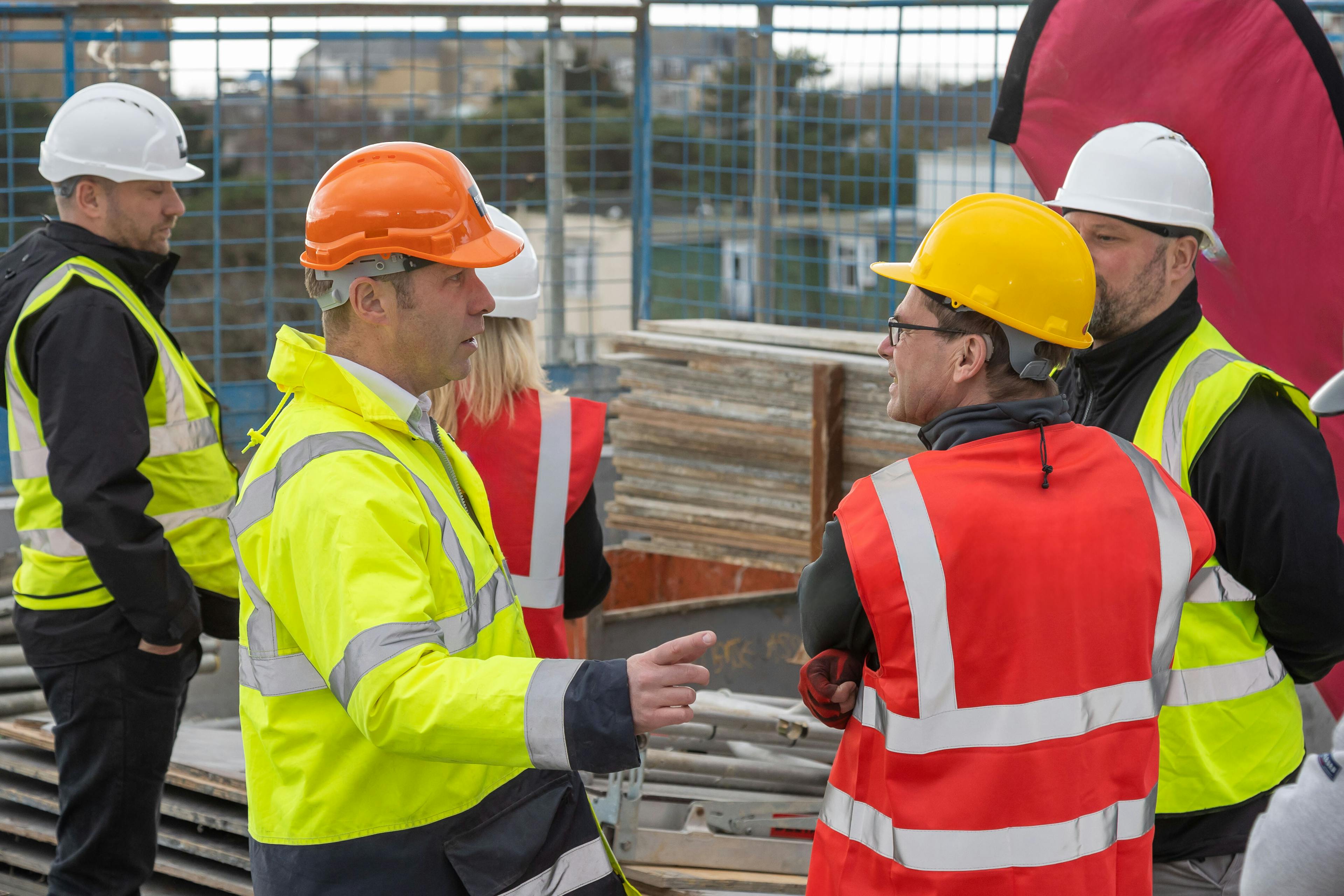 Quantity Surveyor talking to a Project Manager on a construction site